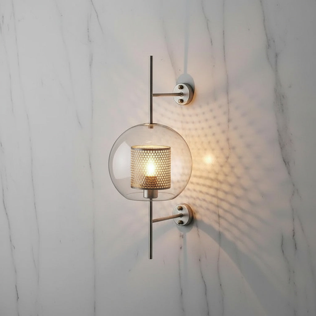 Alegria gold glass wall sconce flanking a bathroom mirror, casting warm light
