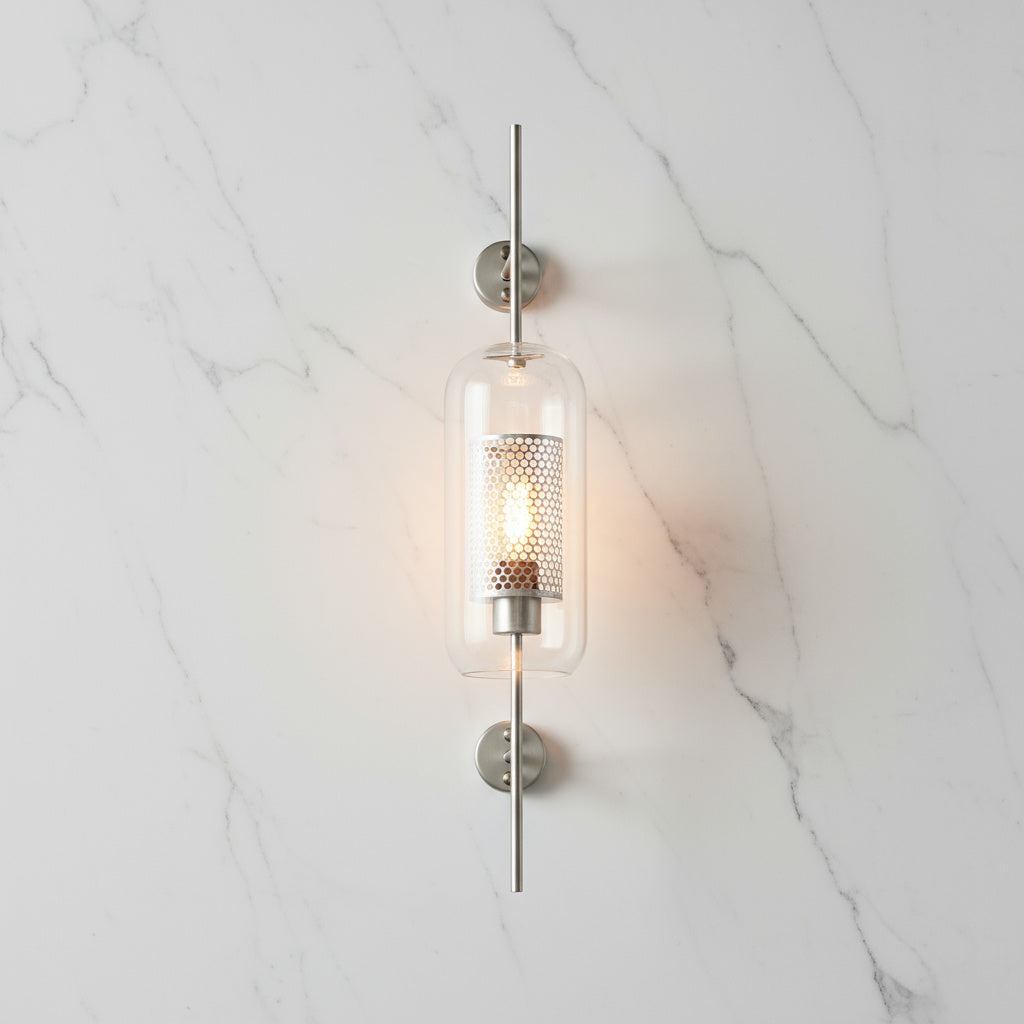 Alegria gold glass wall sconce flanking a bathroom mirror, casting warm light