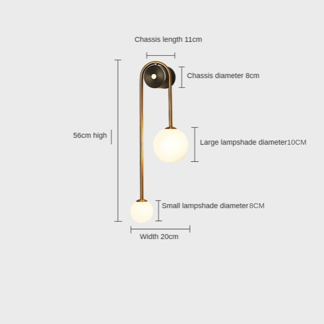 Amalia twin-arm gold Nordic wall sconce with white glass shades flanking a dining room mirror
