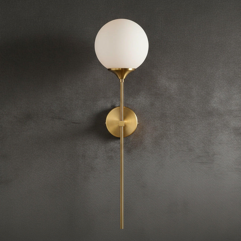 Annika amber glass ball wall sconce mounted in a dining room beside a mirror