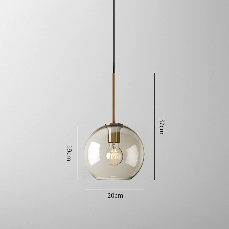 Millay cognac smoked glass pendant light in circle shape above a kitchen island