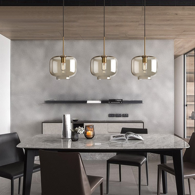 Millay cognac smoked glass pendant light in circle shape above a kitchen island