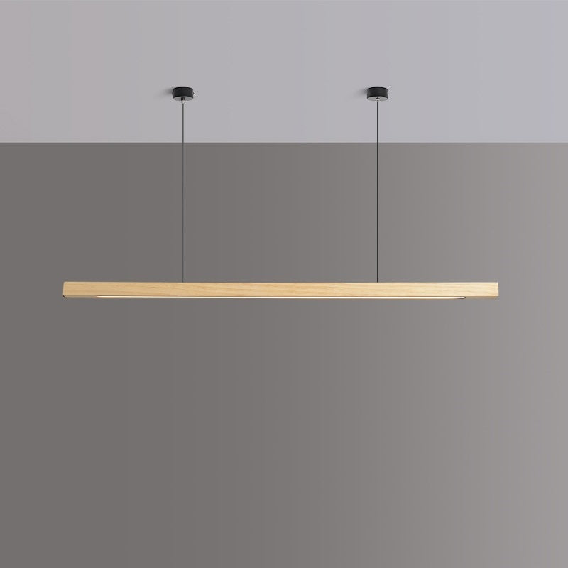 Lindö pine wood dining pendant light hanging low above a long dining table in a Nordic interior