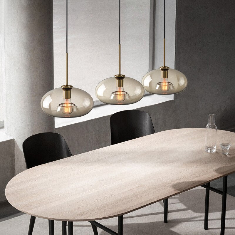 Millay cognac smoked glass pendant light in circle shape above a kitchen island