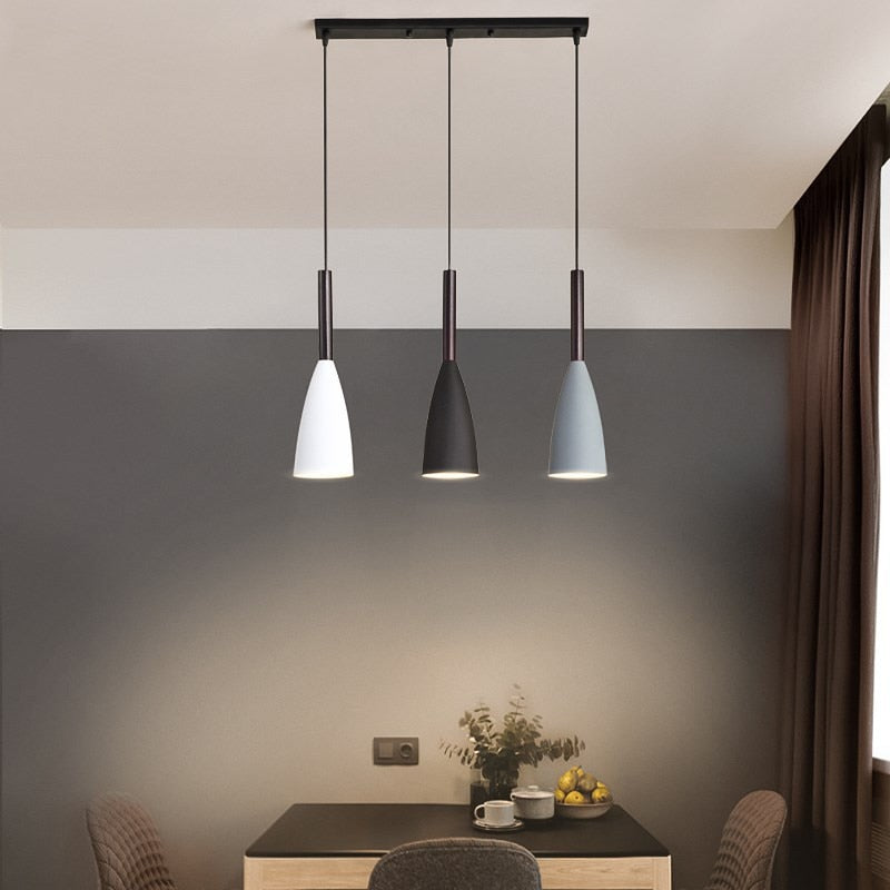 Trine triple aluminium pendant light in white above a kitchen island with adjustable cord lengths