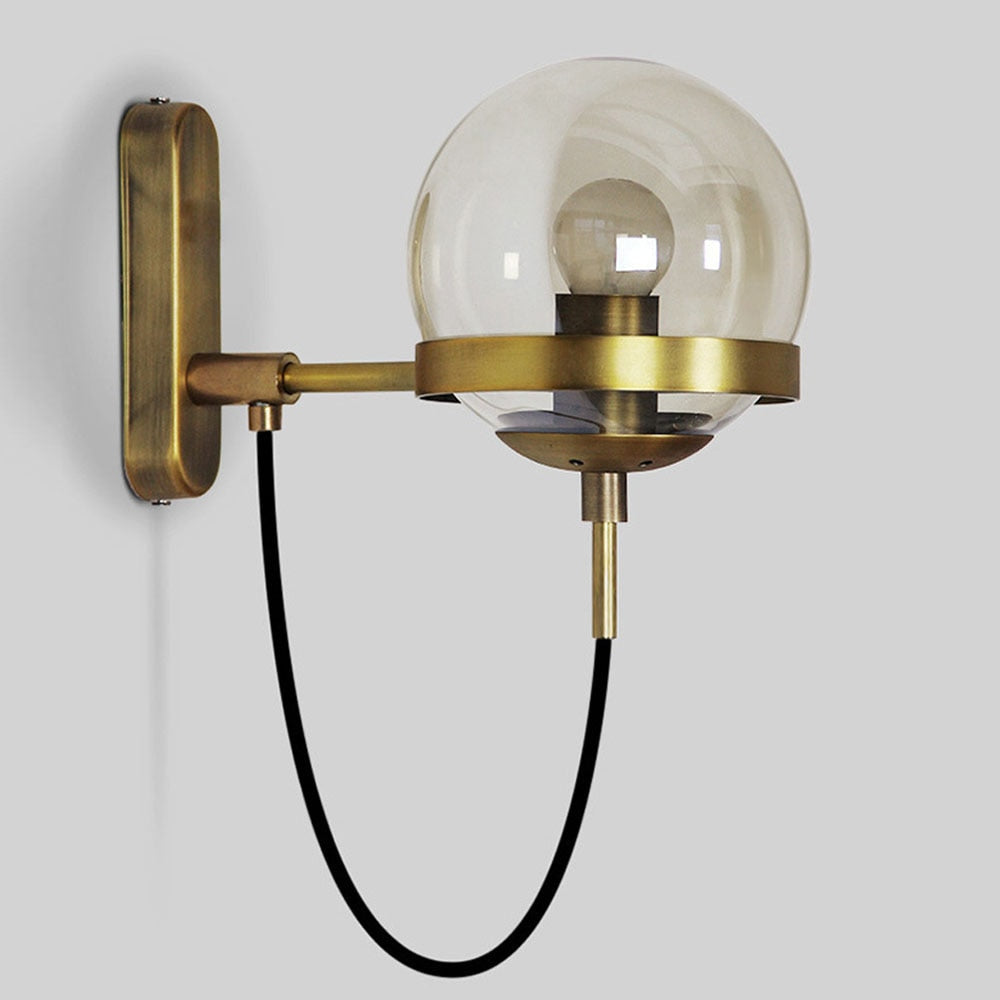 Höskulle glass ball wall sconce in black iron mounted in a bright hallway