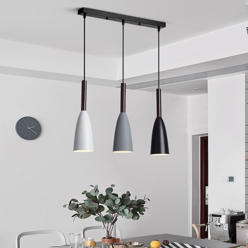 Trine triple aluminium pendant light in white above a kitchen island with adjustable cord lengths