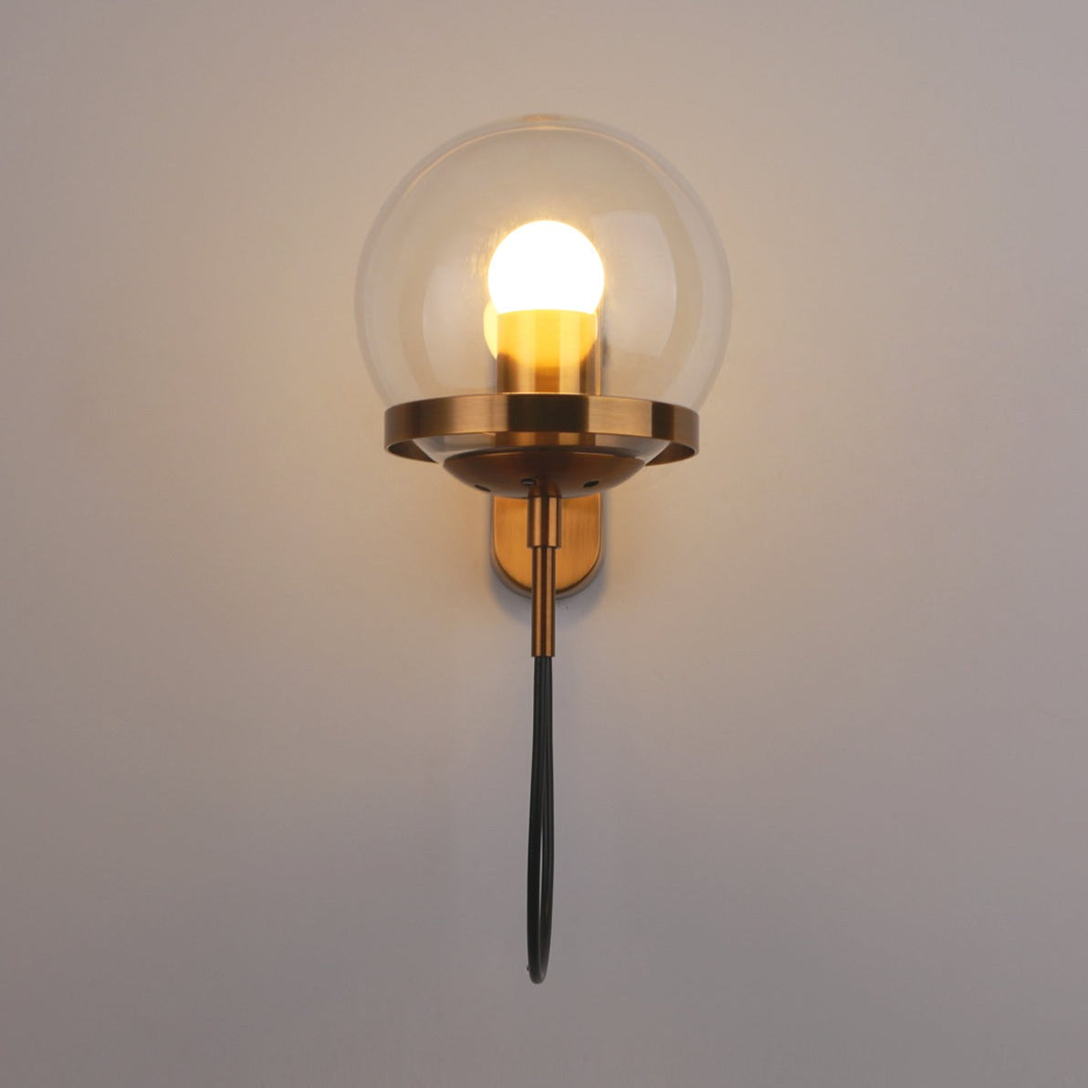 Höskulle glass ball wall sconce in black iron mounted in a bright hallway