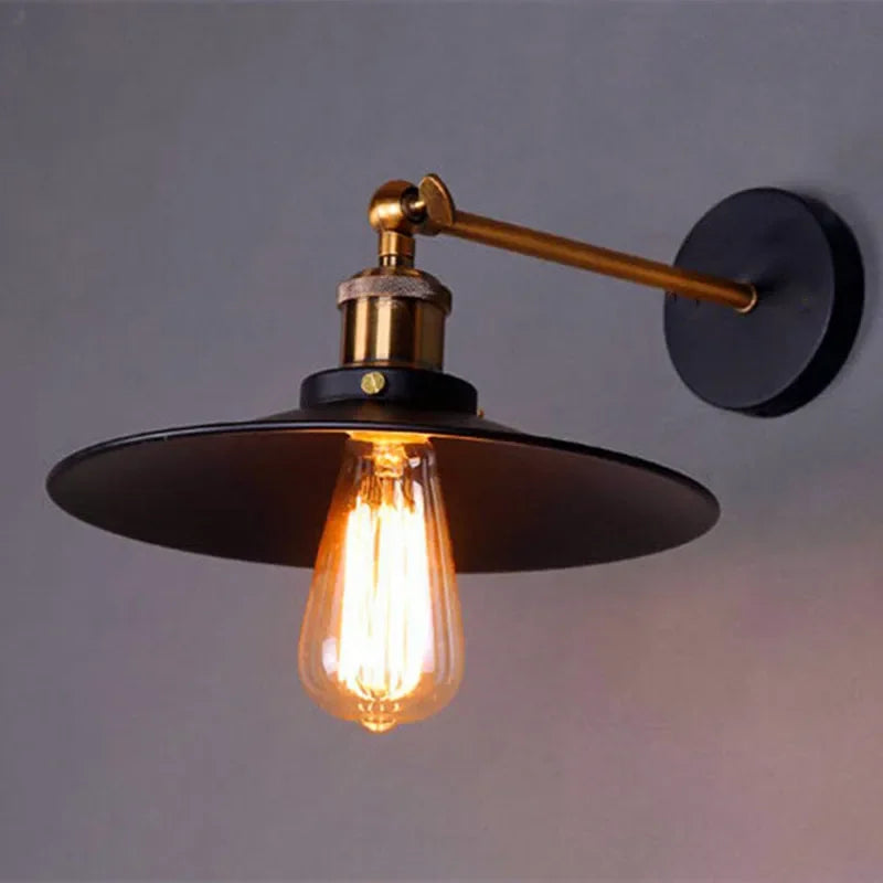 Edison industrial iron wall lamp in matte black mounted on a brick staircase wall