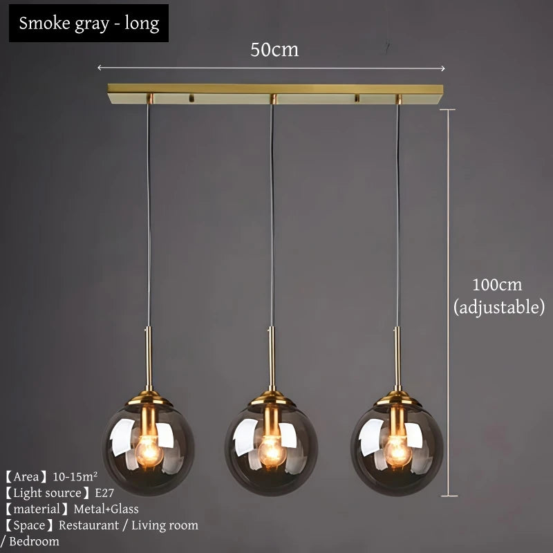 Orla amber glass and metal pendant light hanging above a bedside table in a Nordic-style bedroom