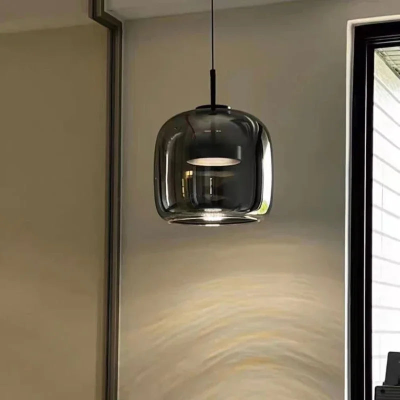Astrid amber glass Nordic pendant light with gold fitting above a dining table