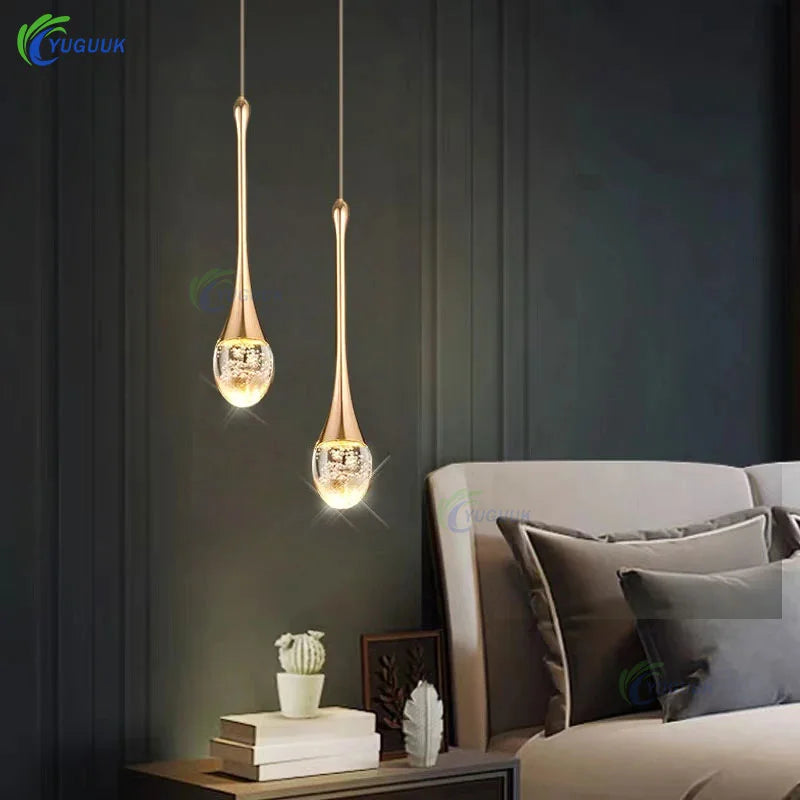 Dewdrop crystal cluster pendant light with multiple glass spheres hanging above a dining table