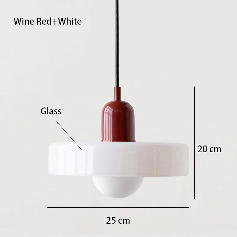 Bauhaus multi-pendant glass chandelier with orange shades hanging above a dining table in a café