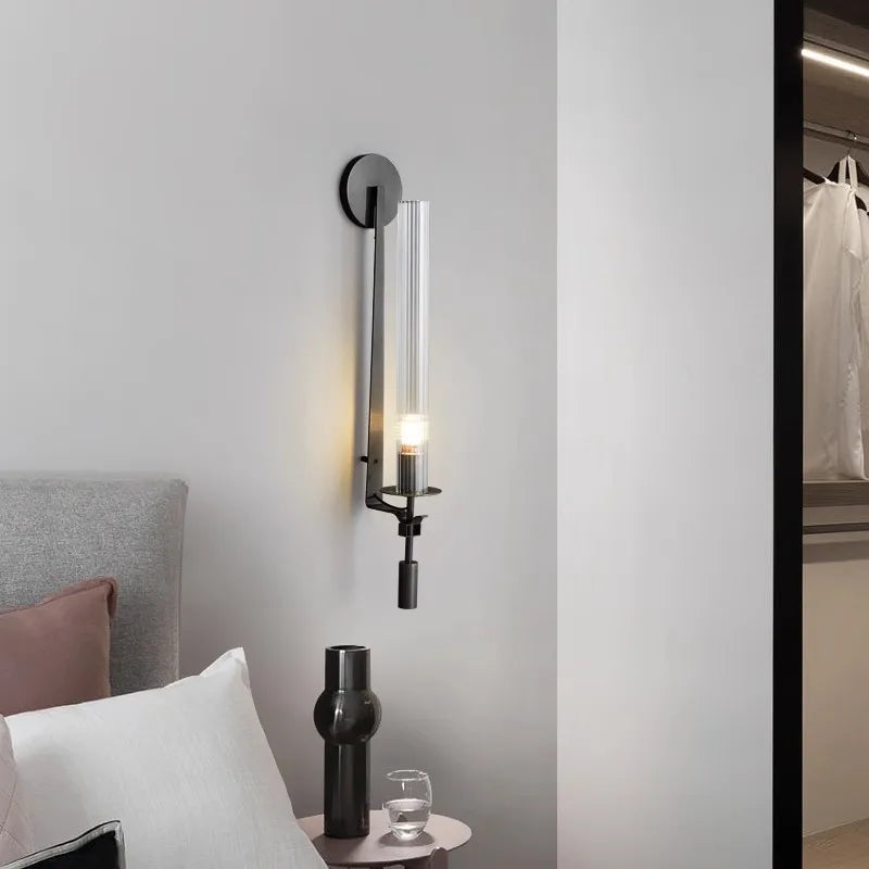 Dagny gold leaf wall sconce with glass element mounted flanking a bed
