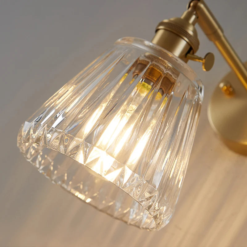 Kyoto brass and glass wall lamp mounted beside a bathroom mirror casting warm light