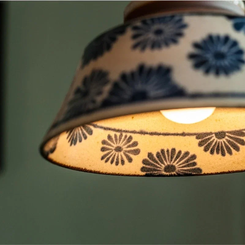 Ronja hand-painted blue floral ceramic pendant light hanging above a kitchen dining nook