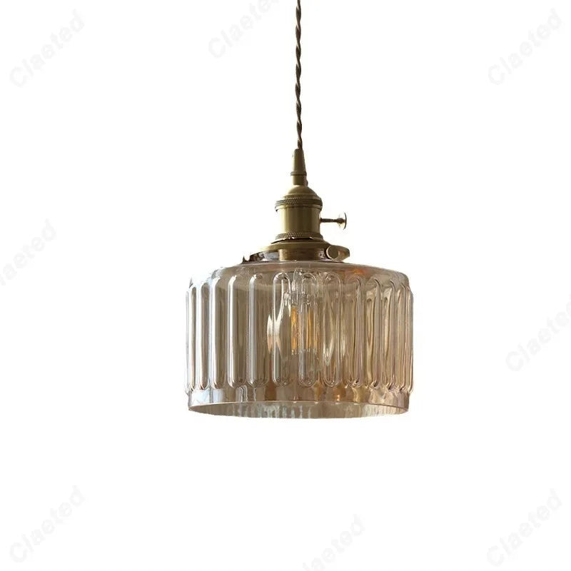 Vessel vintage glass wall lamp mounted beside a bedroom window casting warm ambient light