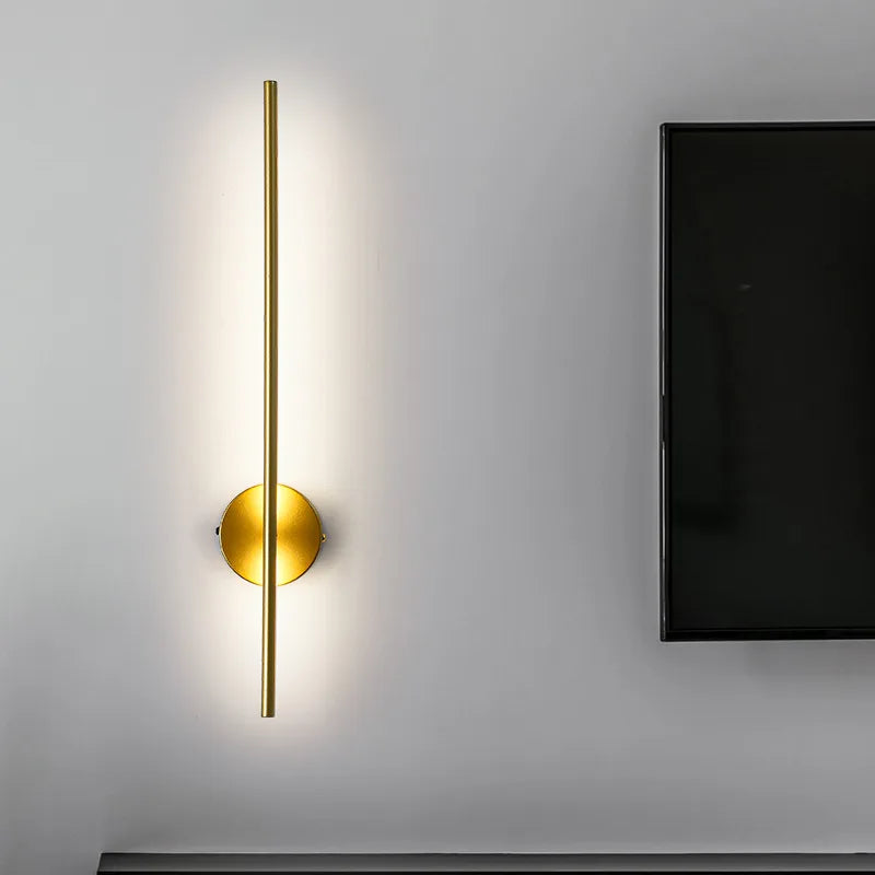 Volta magnetic rechargeable wall lamp in gold mounted in a hallway