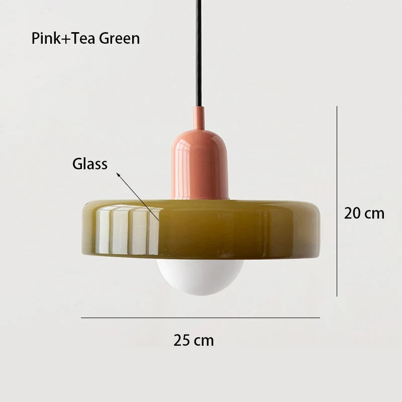 Bauhaus multi-pendant glass chandelier with orange shades hanging above a dining table in a café