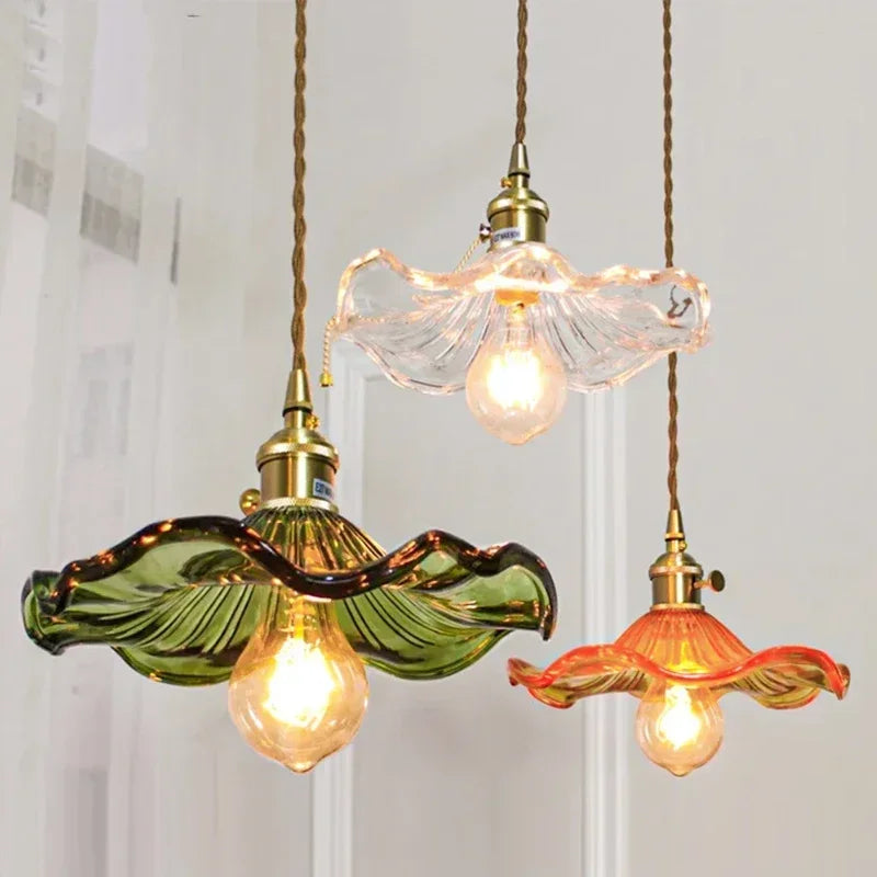Prism green glass pendant light with copper fitting hanging in a dining room