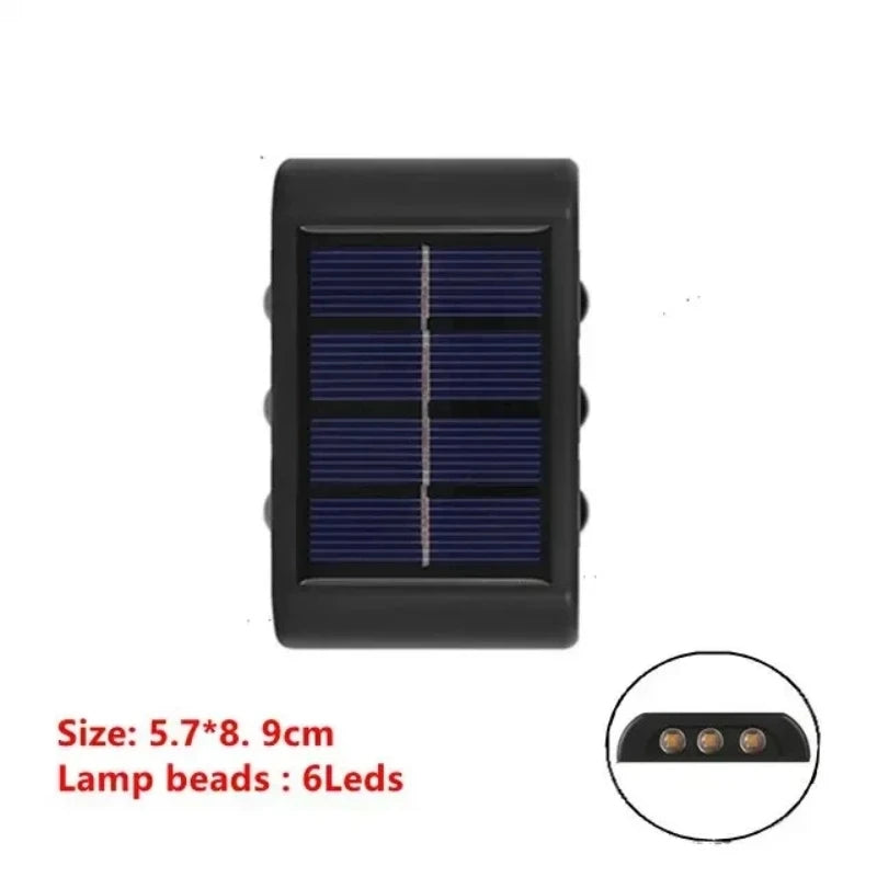 Solstice solar wall light mounted on a garden fence, illuminated at dusk