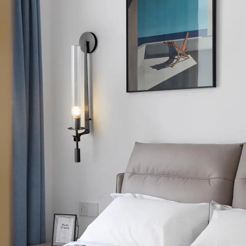Dagny gold leaf wall sconce with glass element mounted flanking a bed
