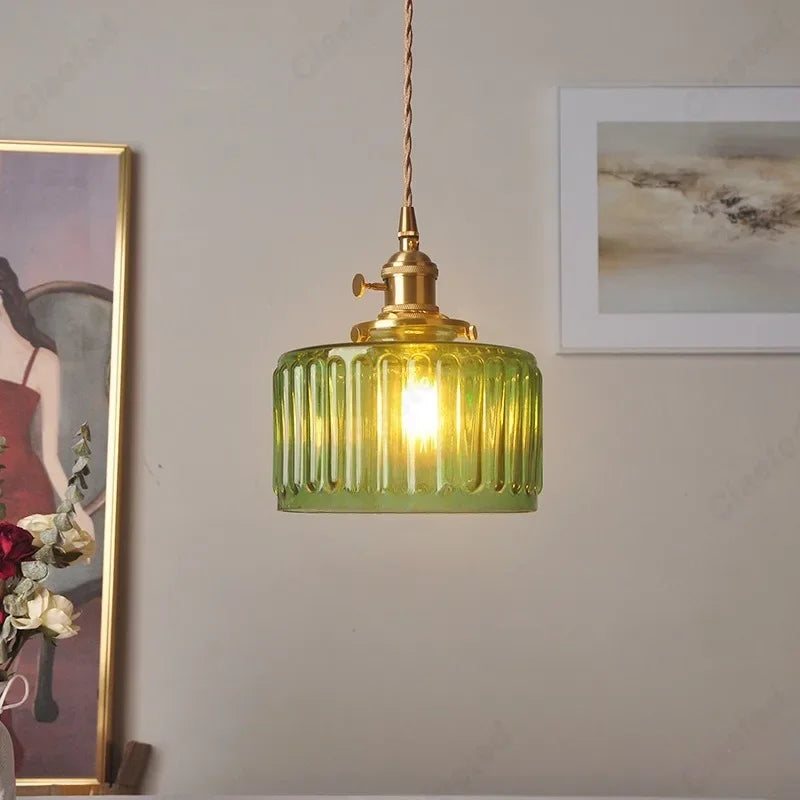 Vessel vintage glass wall lamp mounted beside a bedroom window casting warm ambient light