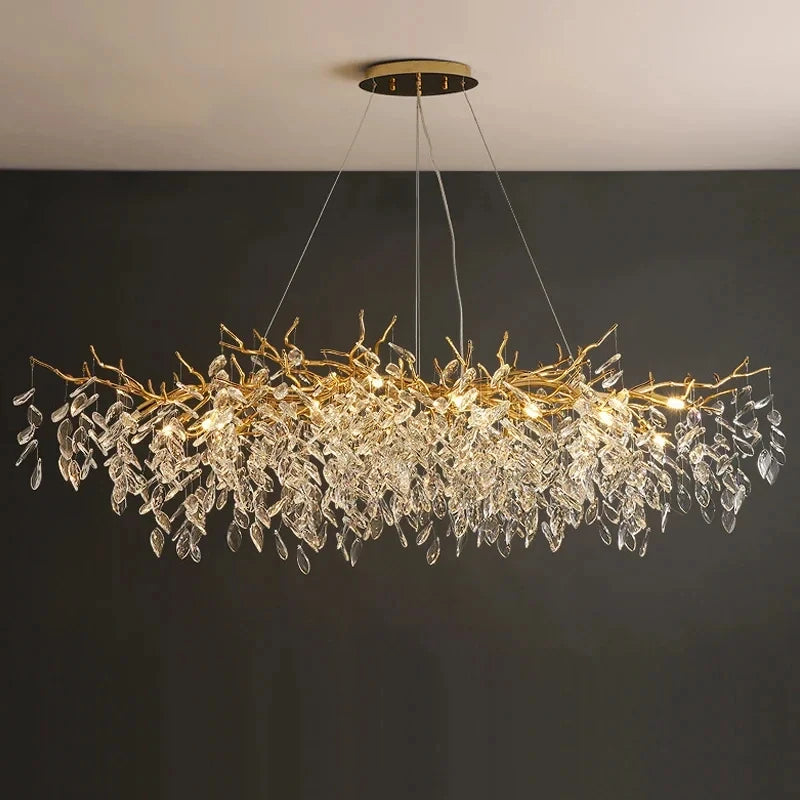 Aurelius brushed gold crystal LED chandelier hanging in a formal dining room