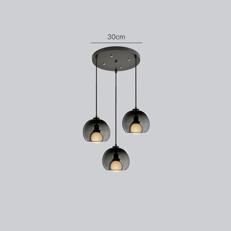 Anele smoke grey dome glass pendant light in a row of three above a kitchen island