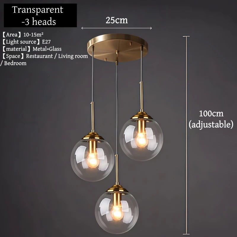 Orla amber glass and metal pendant light hanging above a bedside table in a Nordic-style bedroom