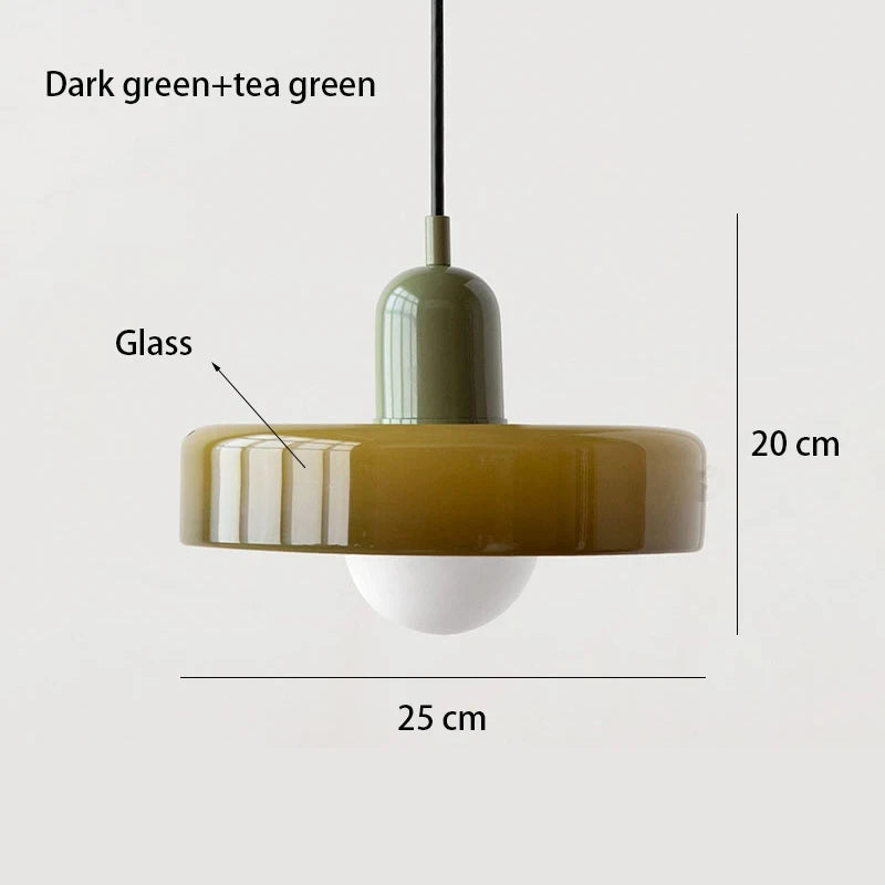 Bauhaus multi-pendant glass chandelier with orange shades hanging above a dining table in a café