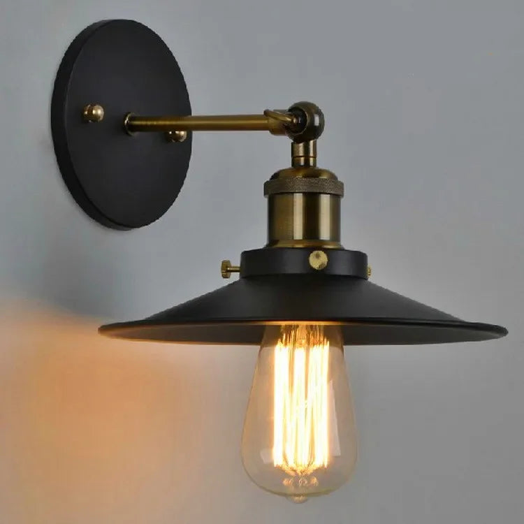 Edison industrial iron wall lamp in matte black mounted on a brick staircase wall