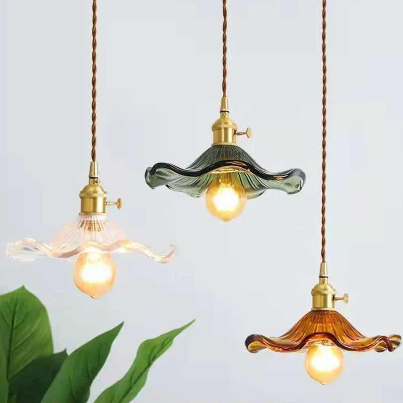Prism green glass pendant light with copper fitting hanging in a dining room