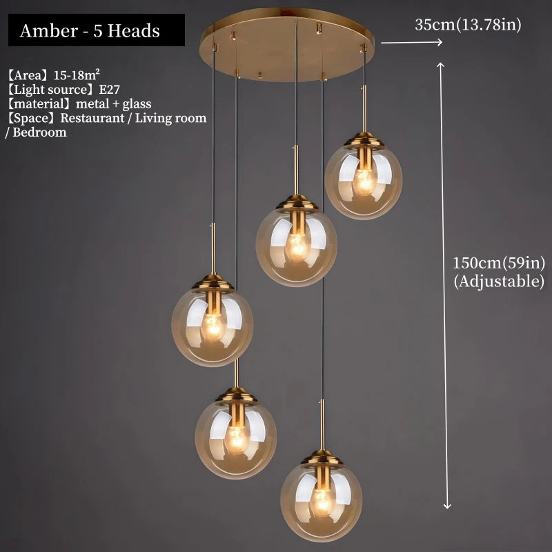 Orla amber glass and metal pendant light hanging above a bedside table in a Nordic-style bedroom