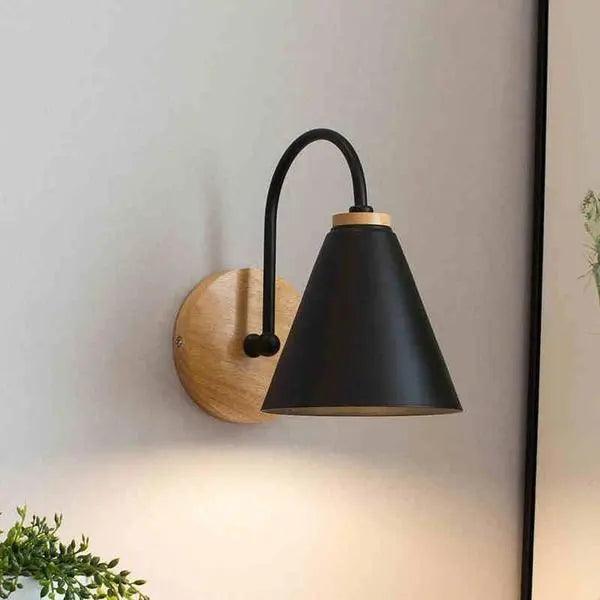 Saskia Nordic wall lamp in black with opal glass shade mounted in a contemporary bedroom