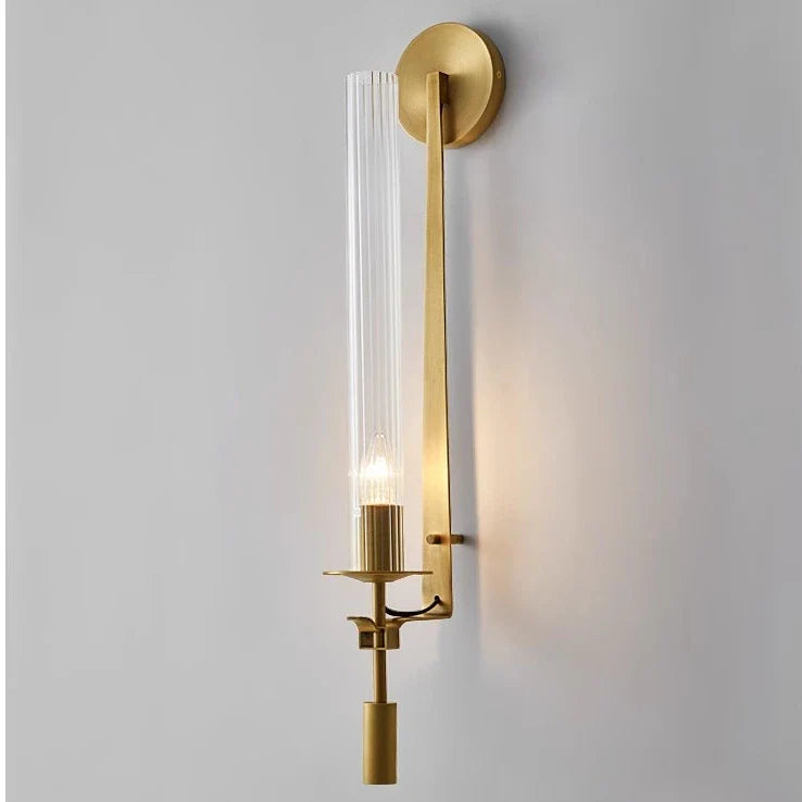 Dagny gold leaf wall sconce with glass element mounted flanking a bed