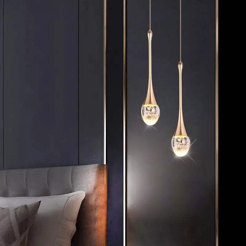 Dewdrop crystal cluster pendant light with multiple glass spheres hanging above a dining table