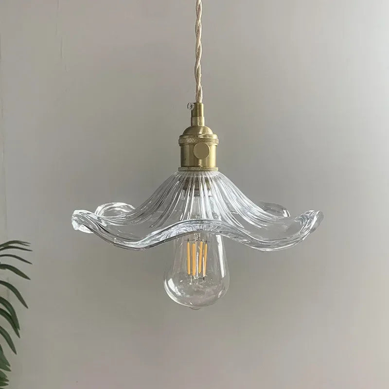 Prism green glass pendant light with copper fitting hanging in a dining room
