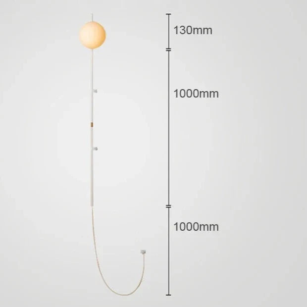 Sol Nordic plug-in wall sconce in black mounted in a living room beside a sofa