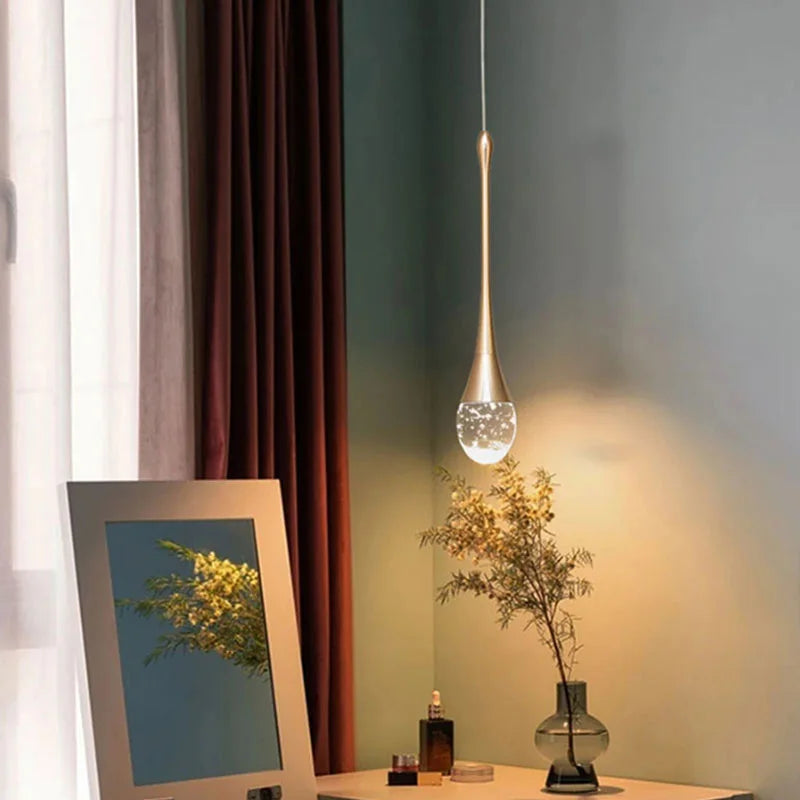Dewdrop crystal cluster pendant light with multiple glass spheres hanging above a dining table
