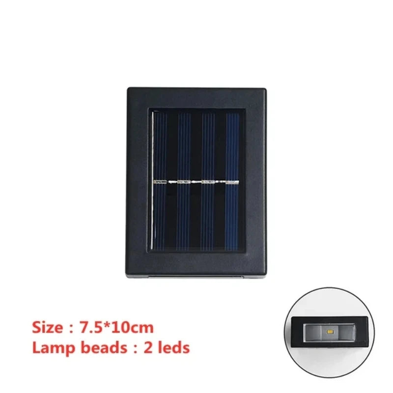 Solstice solar wall light mounted on a garden fence, illuminated at dusk