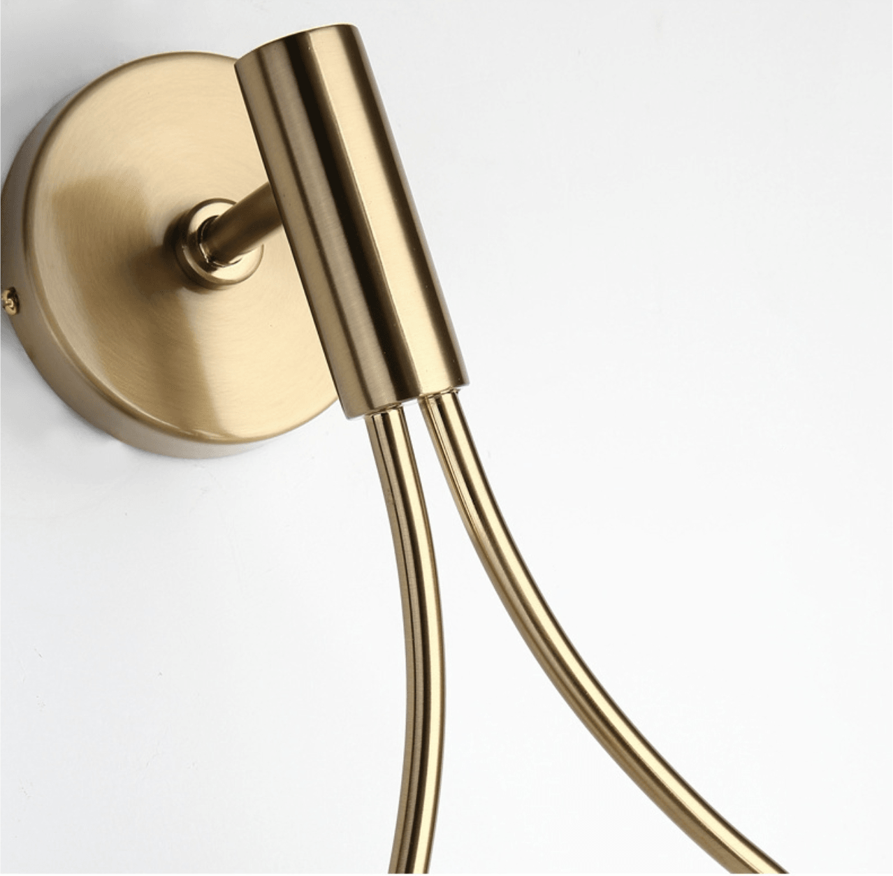 Livi gold Nordic wall sconce mounted beside a bed in a minimalist bedroom