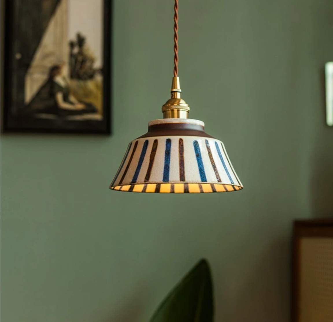 Ronja hand-painted blue floral ceramic pendant light hanging above a kitchen dining nook