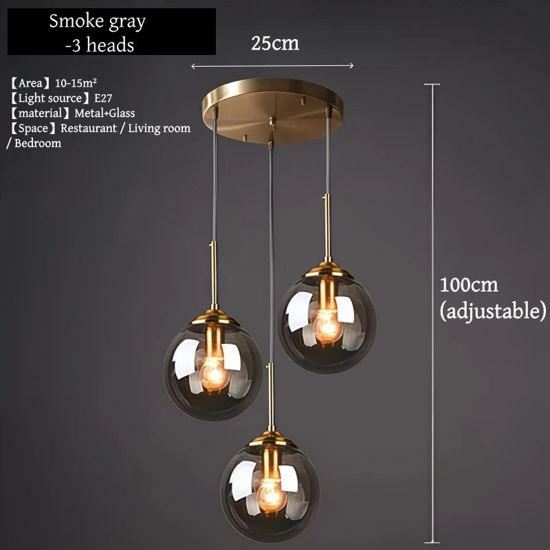 Orla amber glass and metal pendant light hanging above a bedside table in a Nordic-style bedroom