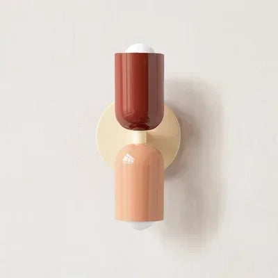 Bijou pastel pink wall lamp mounted in a children's bedroom beside a white bed
