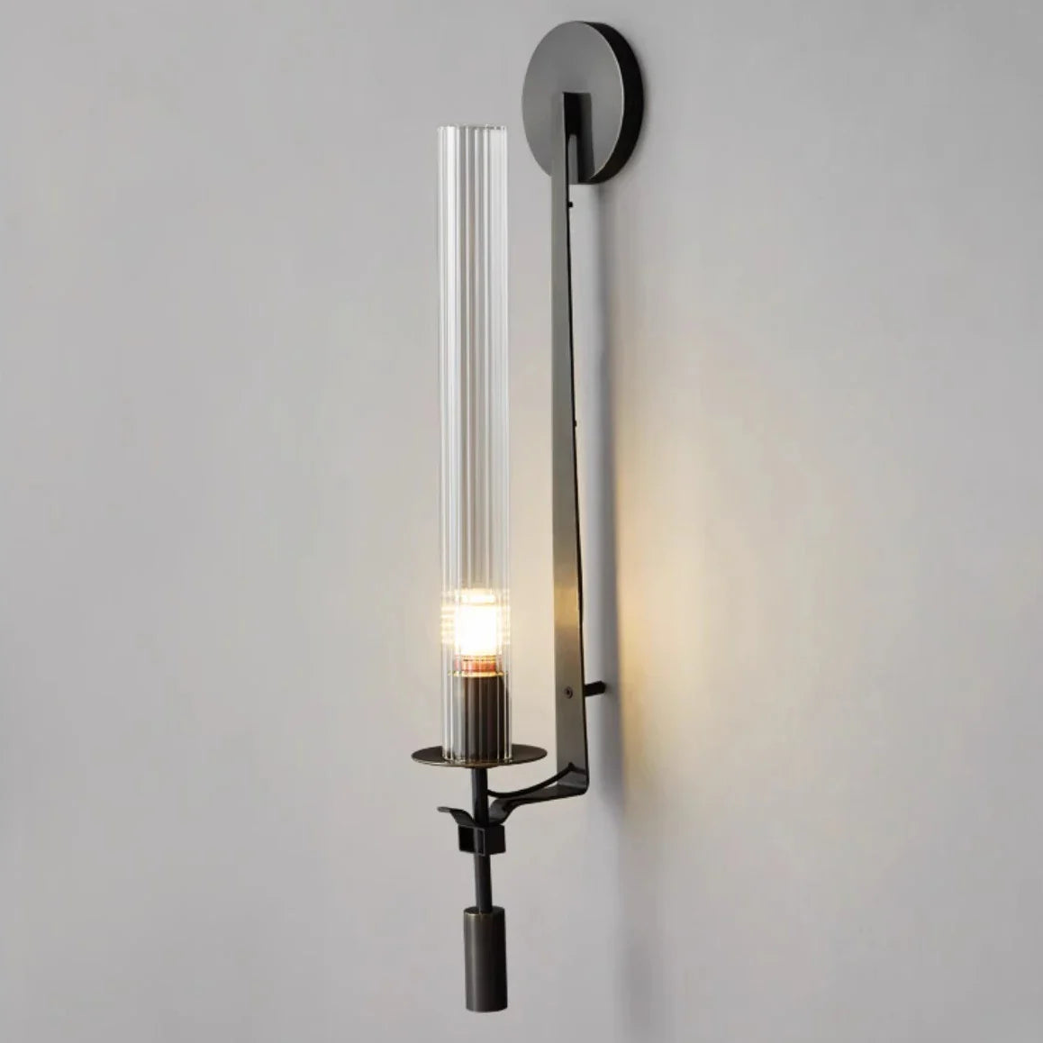 Dagny gold leaf wall sconce with glass element mounted flanking a bed