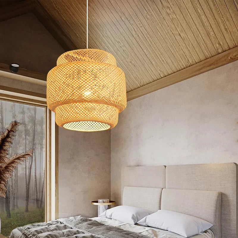 Wren handcrafted woven bamboo pendant light hanging above a wooden dining table in a warm interior