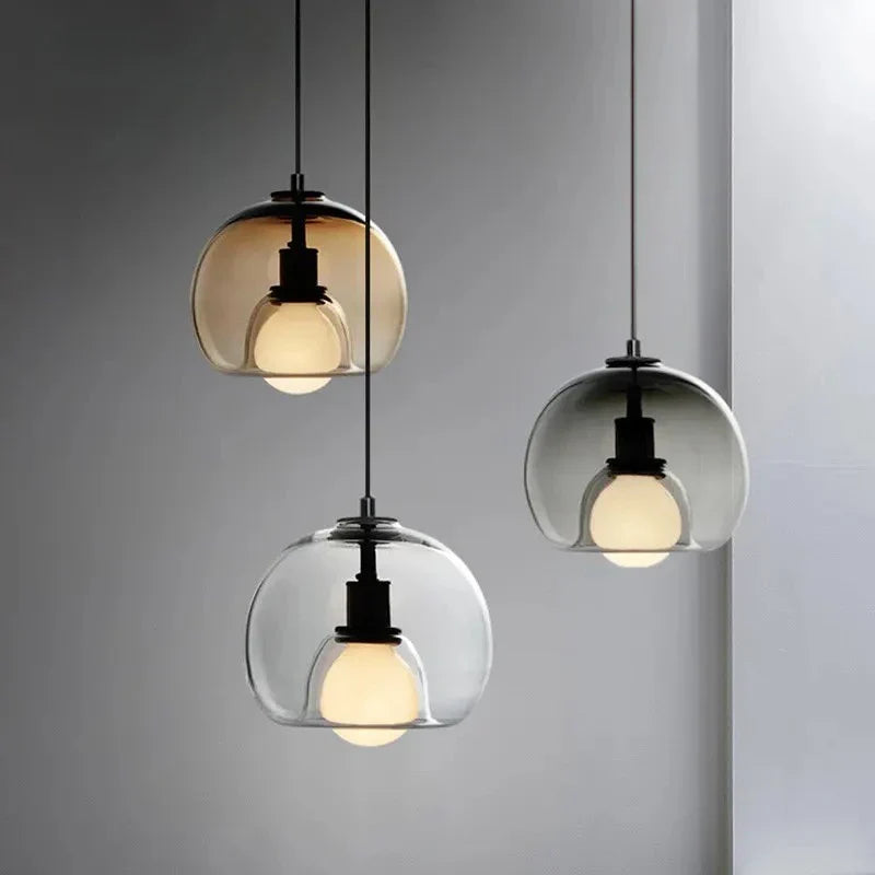 Anele smoke grey dome glass pendant light in a row of three above a kitchen island