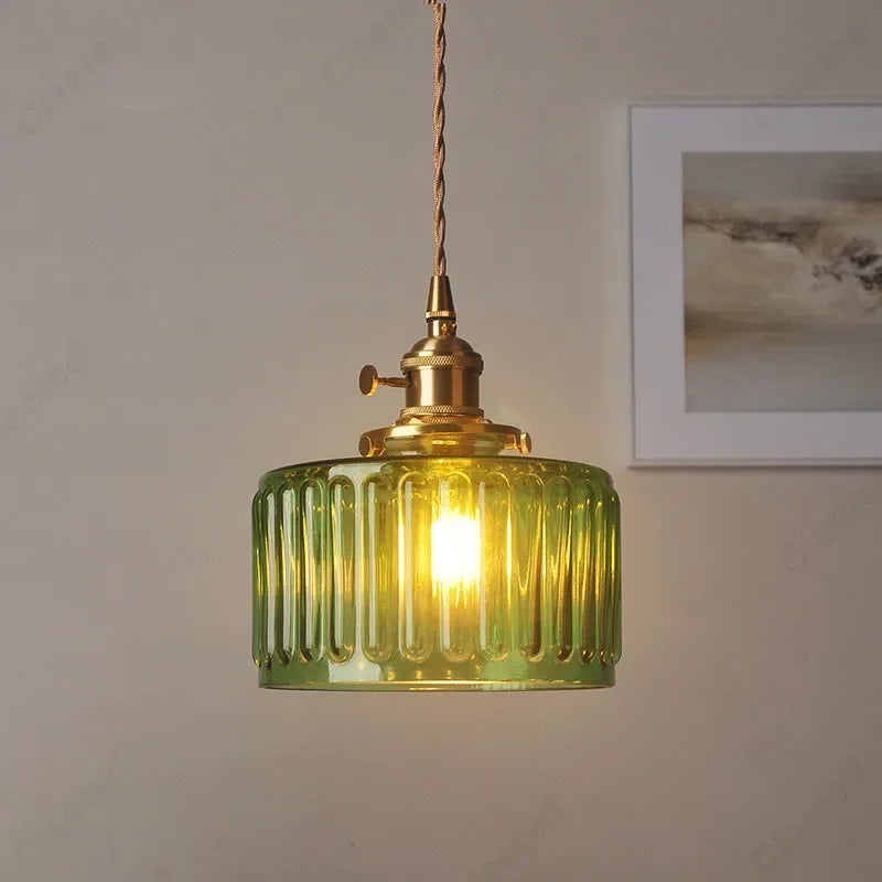 Vessel vintage glass wall lamp mounted beside a bedroom window casting warm ambient light