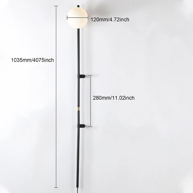 Sol Nordic plug-in wall sconce in black mounted in a living room beside a sofa